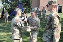 Capt. James Nolla, center, incoming headquarters and headquarters company commander, 85th U.S. Army Reserve Support Command, receives the colors during an assumption of command ceremony on Sunday, October 6, 2024, at the Paul G. Schulstad Army Reserve Center in Arlington Heights, Illinois.