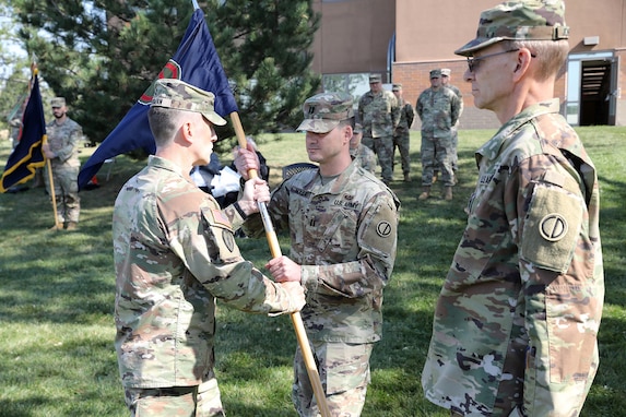 Capt. James Nolla, center, incoming headquarters and headquarters company commander, 85th U.S. Army Reserve Support Command, receives the colors during an assumption of command ceremony on Sunday, October 6, 2024, at the Paul G. Schulstad Army Reserve Center in Arlington Heights, Illinois.