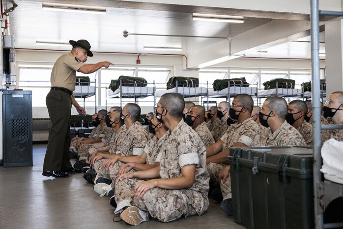 U.S. Marine Corps Staff Sgt. Ioane Laga, left, a senior drill instructor with Charlie Company, 1st Recruit Training Battalion, conducts an initial drill instructor speech to the new recruits at Marine Corps Recruit Depot San Diego, California, Sept. 20, 2024. Pick-up day signifies the first official day of training in which recruits will meet their drill instructor team for the first time, prepare their gear and squad bay, and expectations are set for the remainder of their time in recruit training. (U.S. Marine Corps photo by Cpl. Sarah M. Grawcock)