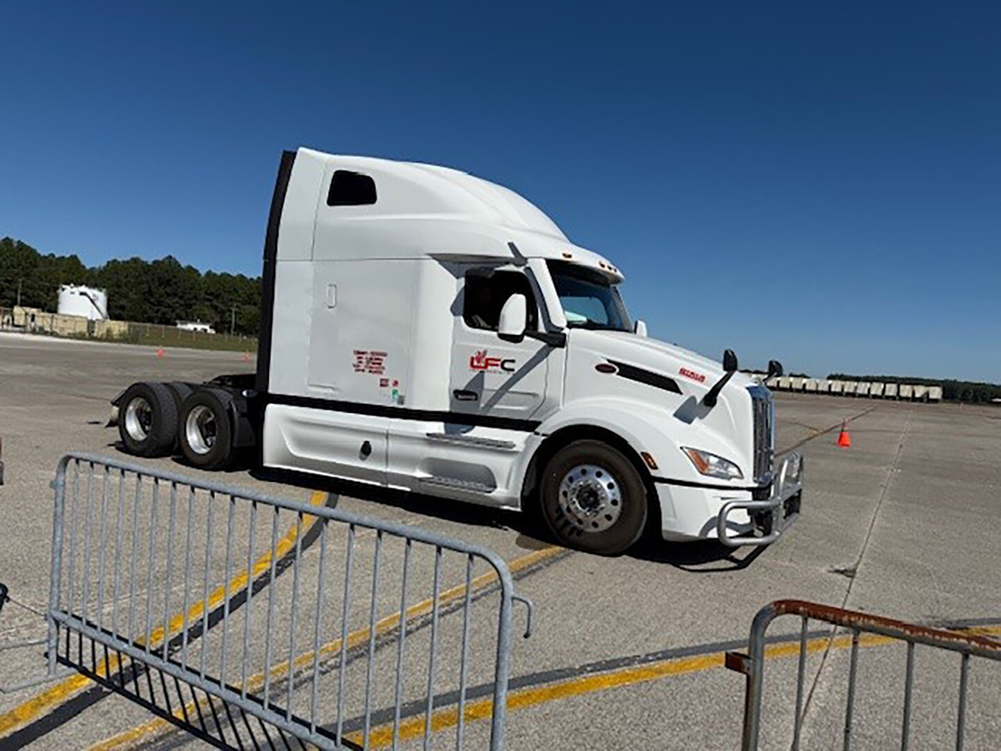 A Tractor trailer is parked outside in a parking lot.