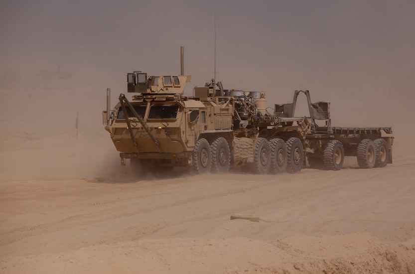 A Logistics System Vehicle Replacement tractor drives down a desert road during a combat logistics patrol conducted by Combat Logistics Regiment 2, Regional Command (Southwest), Aug. 22, 2013, in Helmand province, Afghanistan. More than 30 vehicles took part in the convoy, which provided simultaneous support to Forward Operating Bases Shir Ghazi and Shukvani.