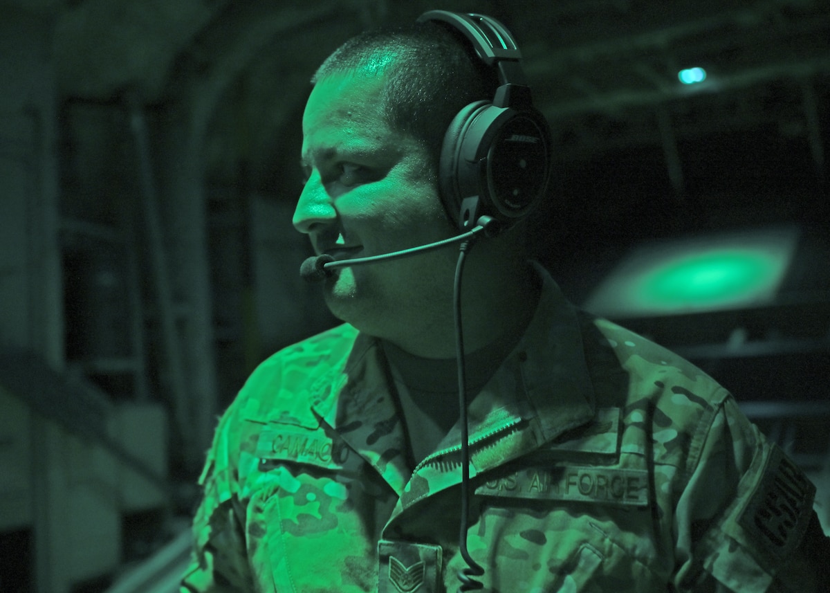 U.S. Air Force Staff Sgt. Bruno Ruizcamacho, 79th Rescue Squadron loadmaster, forward deployed in the 563rd Personnel Recovery Task Force, talks with HC-130J Combat King II aircraft aircrew in North Carolina, Oct. 3, 2024, in support of the U.S. Northern Command and Air Forces Northern, Defense Support of Civil Authorities Disaster Relief mission. The HC-130J is the USAF's only fixed-wing dedicated personnel recovery platform and provides rapidly deployable combat search and rescue forces to theater commanders worldwide. It conducts helicopter air-to-air refueling and airdrop of pararescue personnel and/or equipment in support of combat or civilian personnel recovery. (U.S. Air Force photo by Staff Sgt. Abbey Rieves)
