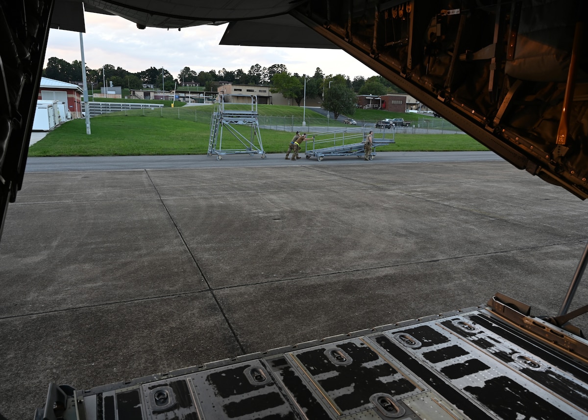 U.S. Airmen assigned to the 79th Rescue Generation Squadron, forward deployed in the 563rd Personnel Recovery Task Force, clear the flightline for an HC-130J Combat King II aircraft at McGhee Tyson Air National Guard Base, Tennessee, Oct. 3, 2024, in support of the U.S. Northern Command and Air Forces Northern, Defense Support of Civil Authorities Disaster Relief mission. The HC-130J is the only dedicated fixed-wing personnel recovery platform in the Air Force inventory. (U.S. Air Force photo by Staff Sgt. Abbey Rieves)