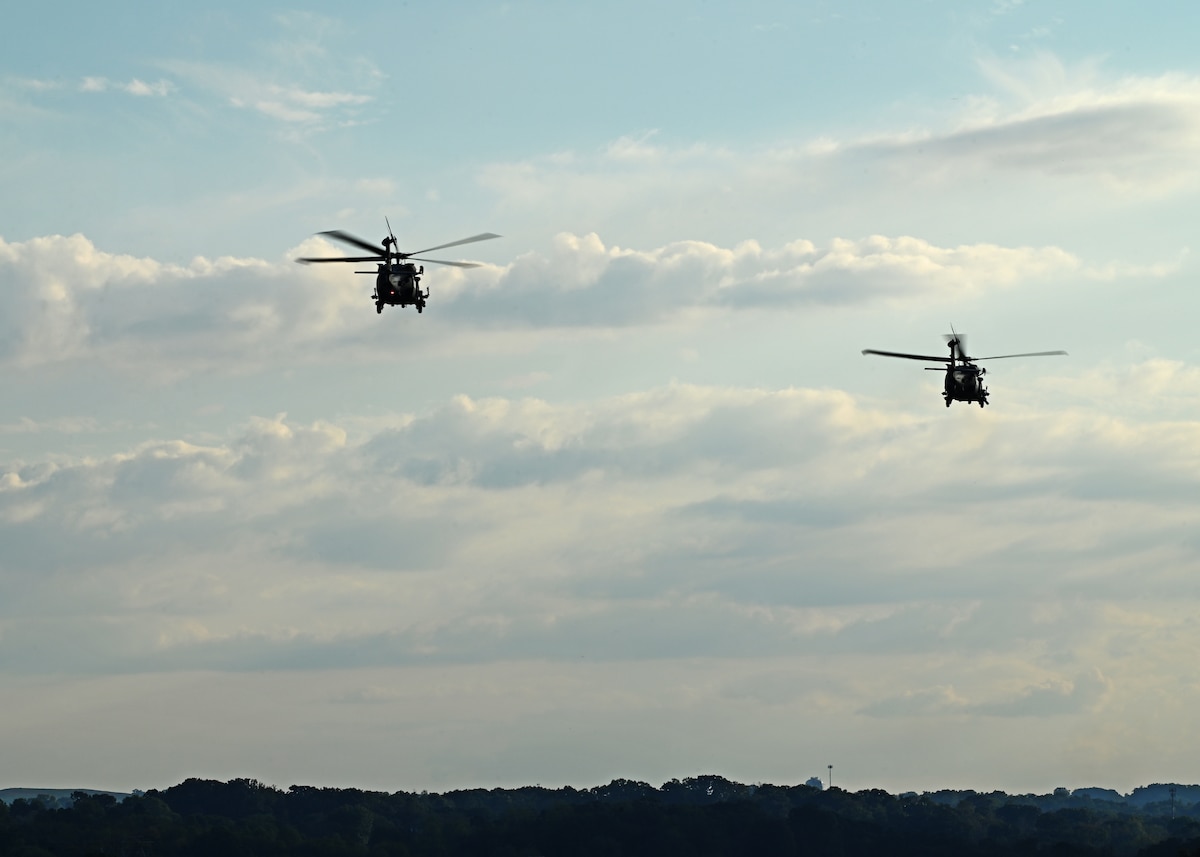 Two HH-60W Jolly Green II helicopters assigned to the 55th Rescue Squadron, forward deployed in the 563rd Personnel Recovery Task Force, launch for search and rescue operations from McGhee Tyson Air National Guard Base, Tennessee, Oct. 3, 2024, in support of the U.S. Northern Command and Air Forces Northern, Defense Support of Civil Authorities Disaster Relief mission. U.S. Airmen operate on Title 10 orders to provide necessary support to civilian authorities during natural disasters when directed and approved by the Secretary of Defense. (U.S. Air Force photo by Staff Sgt. Abbey Rieves)