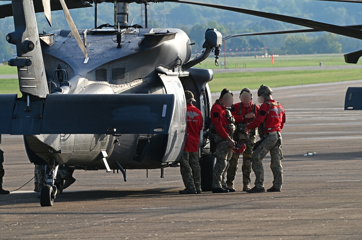 U.S. pararescuemen assigned to the 48th Rescue Squadron, forward deployed as the 563rd Personnel Recovery Task Force, strategize before take off at McGhee Tyson Air National Guard Base, Tennessee, Oct. 3, 2024, in support of the U.S. Northern Command and Air Forces Northern, Defense Support of Civil Authorities Disaster Relief mission. Davis-Monthan Air Force Base’s rescue assets received its first tasking for search and rescue capabilities. (U.S. Air Force photo by Staff Sgt. Abbey Rieves) (U.S. Air Force photo by Staff Sgt. Abbey Rieves) (Note this photo has been altered for security purposes by blurring out facial identification.)