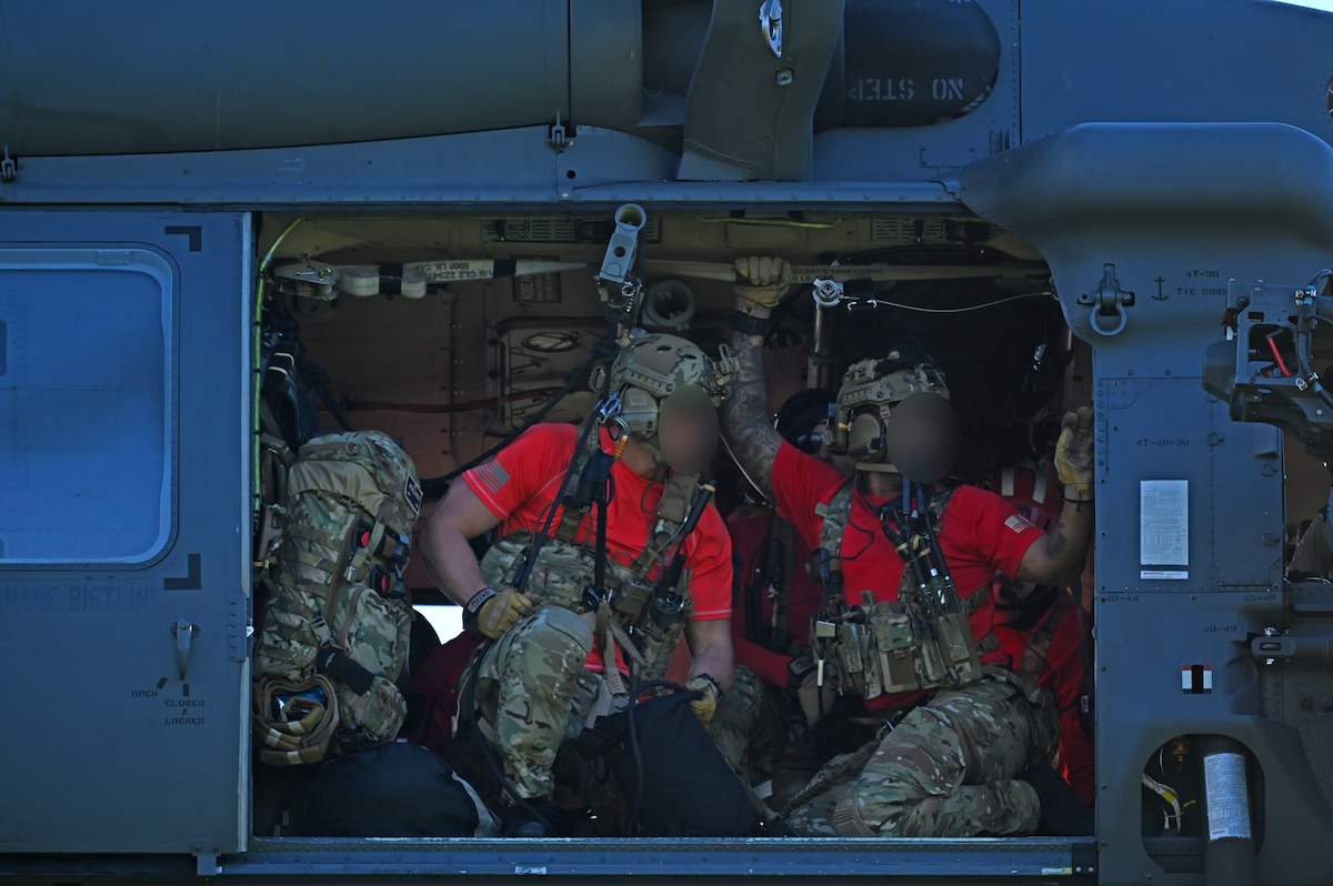 U.S. Airmen assigned to the 48th Rescue Squadron, forward deployed as the 563rd Personnel Recovery Task Force, prepare to repel from an HH-60W Jolly Green II helicopter in Tennessee, Oct. 2, 2024, in support of the U.S. Northern Command and Air Forces Northern, Defense Support of Civil Authorities Disaster Relief mission. The Department of Defense's defense support of civil authorities demonstrates our Nation’s readiness, responsiveness, capability, and resilience. (U.S. Air Force photo by Staff Sgt. Abbey Rieves) (Note this photo has been altered for security purposes by blurring out facial identification.)