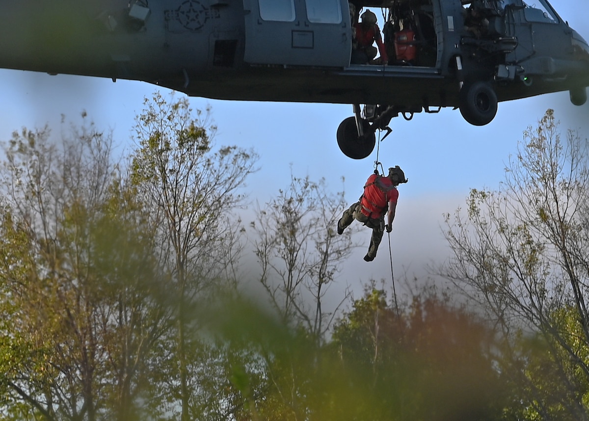 A U.S. Airman assigned to the 48th Rescue Squadron practices repelling from an HH-60W Jolly Green II helicopter in Tennessee, Oct. 2, 2024, in support of the U.S. Northern Command and Air Forces Northern, Defense Support of Civil Authorities Disaster Relief mission. The rescue team from Davis-Monthan Air Force Base, Arizona forward deployed more than 100 personnel within 12 hours to support rescue and recovery operations of civilians impacted by Hurricane Helene. (U.S. Air Force photo by Staff Sgt. Abbey Rieves)
