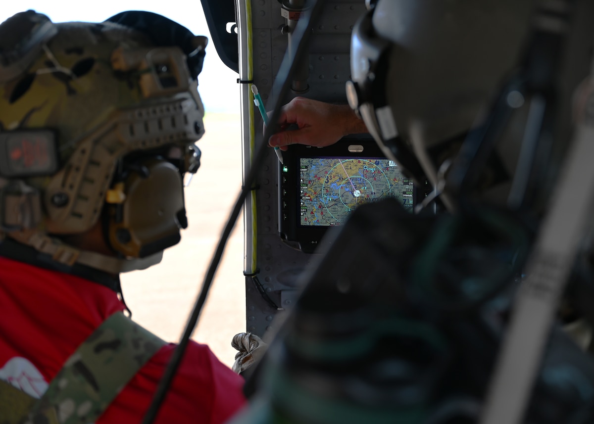 U.S. Airmen assigned to the 48th Rescue Squadron and 55th Rescue Squadron, forward deployed as the 563rd Personnel Recovery Task Force, discuss a flight route at various locations in Tennessee, Oct. 2, 2024, in support of the U.S. Northern Command and Air Forces Northern, Defense Support of Civil Authorities Disaster Relief mission. The 563rd PRTF conducted mission rehearsals in preparation for rescue and recovery operations to serve residents impacted by Hurricane Helene. (U.S. Air Force photo by Staff Sgt. Abbey Rieves)
