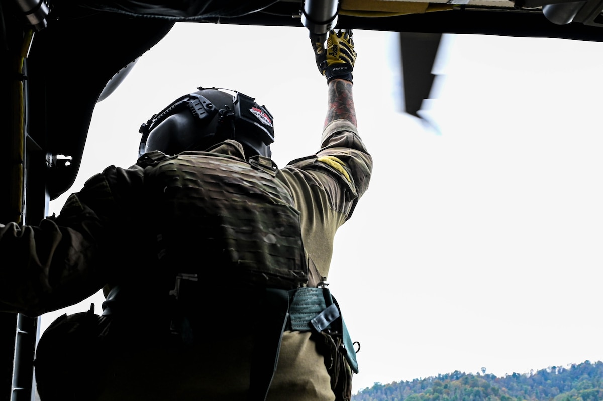 U.S. Air Force Tech. Sgt. Philip Jimenez assigned to the 55th Rescue Squadron, forward deployed as the 563rd Personal Recovery Task Force, prepares to lower a hoist over various locations in North Carolina, Oct. 4, 2024, in support of the U.S. Northern Command and Air Forces Northern, Defense Support of Civil Authorities Disaster Relief mission. The task force utilized a variety of aircraft to provide humanitarian support during search and rescue operations to those impacted by Hurricane Helene. (U.S. Air Force photo by Senior Airman Andrew Garavito)