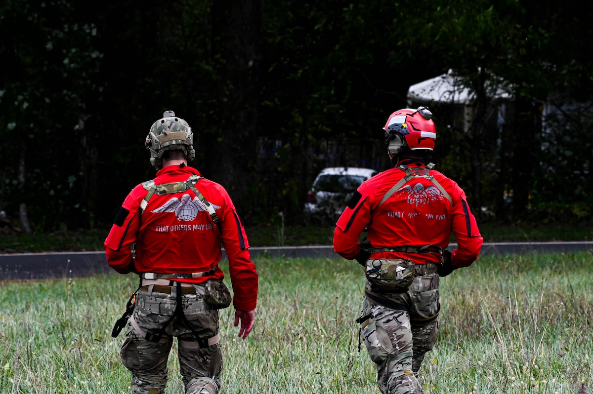 U.S. Air Force pararescuemen assigned to the 48th Rescue Squadron, forward deployed as the 563rd Personal Recovery Task Force, dismount from an HH-60W Jolly Green II helicopter to support local civilians over various locations in North Carolina, Oct. 4, 2024, in support of the U.S. Northern Command and Air Forces Northern, Defense Support of Civil Authorities Disaster Relief mission.  More than 100 personnel from Davis-Monthan Air Force Base, Arizona forward deployed to support rescue and recovery operations of Americans impacted by Hurricane Helene. (U.S. Air Force photo by Senior Airman Andrew Garavito)