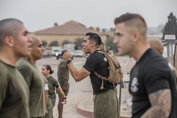 U.S. Marine Corps Staff Sgt. Alexander Cevalles, an instructor with Marine Corps Recruit Depot San Diego Drill Instructor School, Recruit Training Regiment, directs Marines after the three-mile run portion of the physical fitness test at Marine Corps Recruit Depot San Diego, California, Oct. 4, 2024. DI School develops leadership, command presence, instructional ability, physical fitness, and professional knowledge in officers, staff noncommissioned and noncommissioned officers to prepare them for the duties of a drill instructor. (U.S. Marine Corps photo by Cpl. Alexandra M. Earl)
