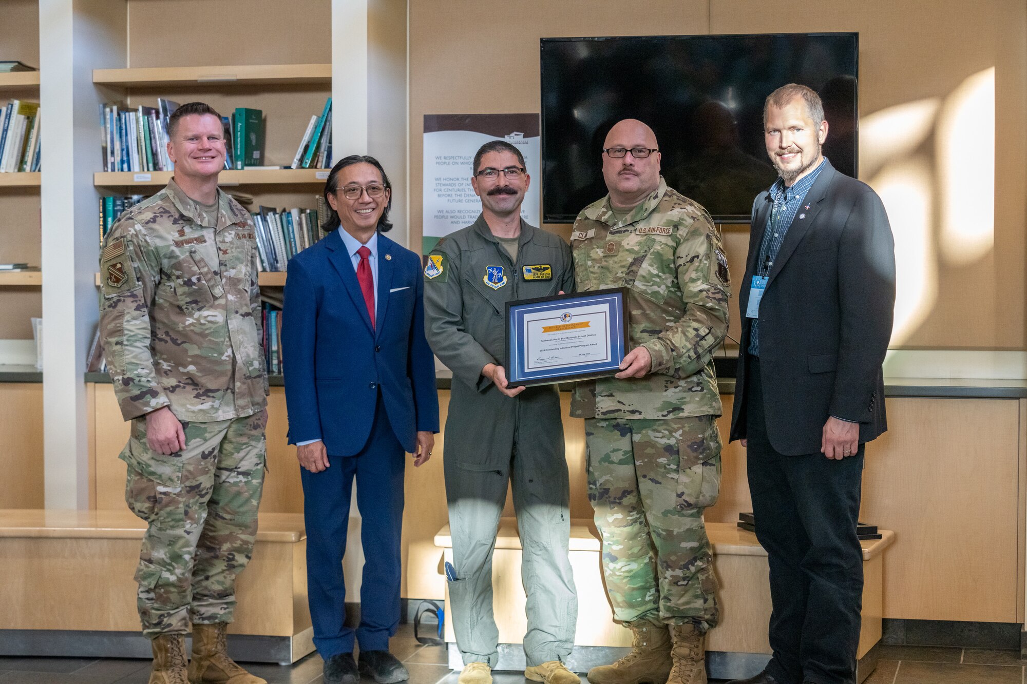 Lt. Col. Jeffrey Boesche and Senior Master Sgt. Clay Clark of the 168th Wing, Alaska Air National Guard, pose for a photo after being presented with the Pete Taylor Partnership of Excellence Award for volunteering as mentors for the Fairbanks North Borough School District PreApprenticeship Program.