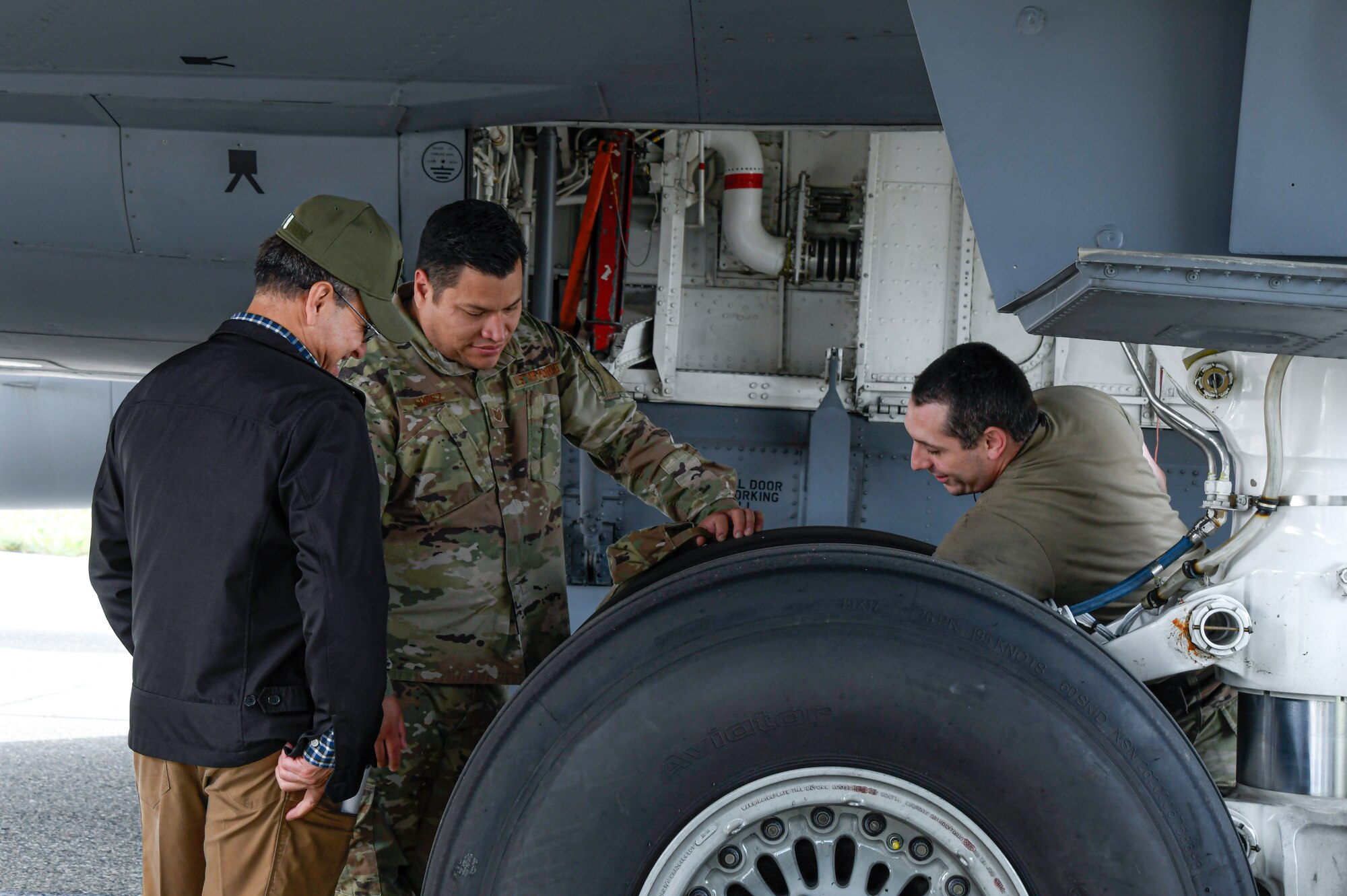 Tech Sgt. Blayne Kiser of the 168th Maintenance Group, right, explained the KC-135 Stratotanker hydraulics and the extensive maintenance that occurs to keep the aircraft on the air refueling mission during the 168thWing Bring a Buddy Day event on Aug 1, 2024.  The 168 WG held a Bring-a-Buddy to Work Day, inviting friends, family, and community partners to visit and learn about the wing’s mission and jobs.