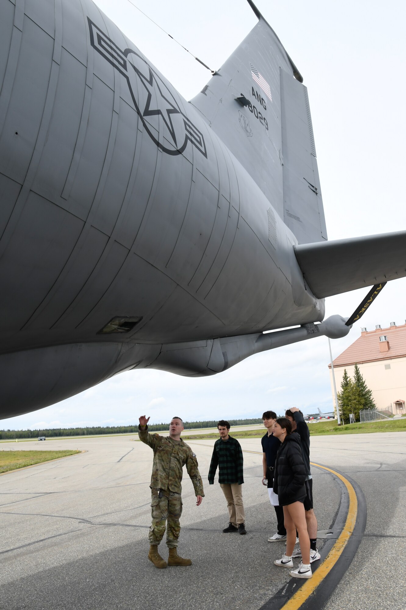 Master Sgt. Craig Cummings, 168th Maintenance Group, visits with community members and explains the KC-135 Stratotanker mission and the inspections that occur to keep the aircraft on the air refueling mission during the 168th Wing Bring a Buddy Day event on Aug 1, 2024.