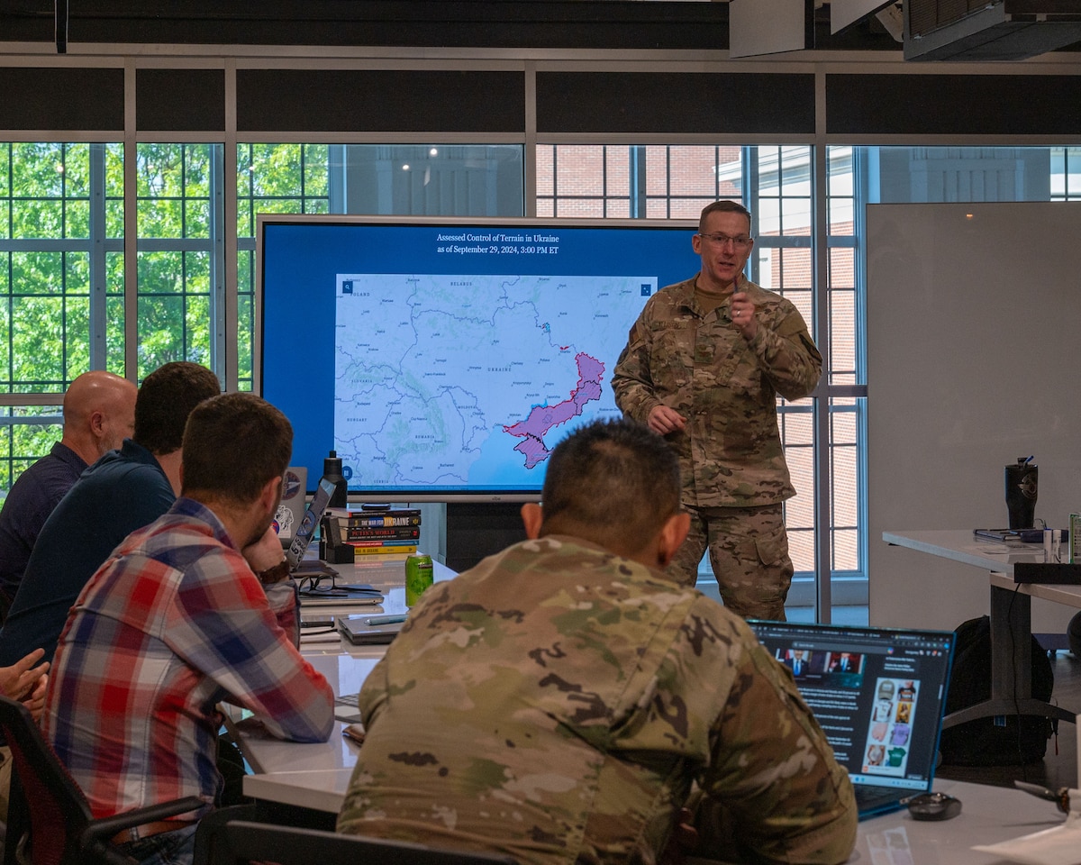 U.S. Air Force Col. Russell Allison, Associate Dean of Faculty, Air War College, gives a briefing to the Innovation Research Task Force students at Montgomery, Alabama, Oct. 2, 2024. Throughout the course, students will hear from military and private industry innovation leaders about how they approach problems, and how they develop and implement processes to accelerate innovation. (U.S. Air Force photo by Senior Airman Evan Lichtenhan)