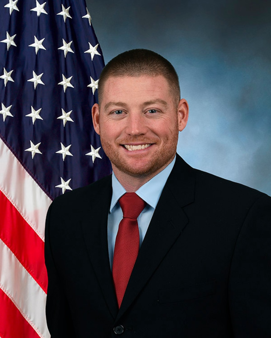 Portrait of man with USA Flag in background