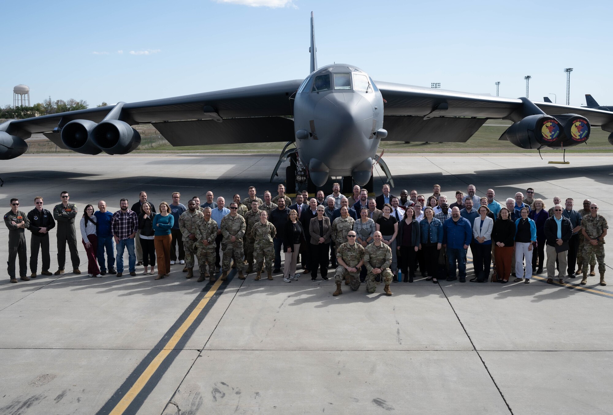 City of Minot religious leaders and Minot Air Force Base Airmen pose for a group photo in front of a B-52H Stratofortress during the 5th Bomb Wing (5 BW) Chaplain Corps Clergy Day tour at Minot Air Force Base, North Dakota, Oct. 2, 2024. The Minot Air Force Chaplain Corps led local religious leaders around the base with help from 5 BW and the 91st Missile Wing.