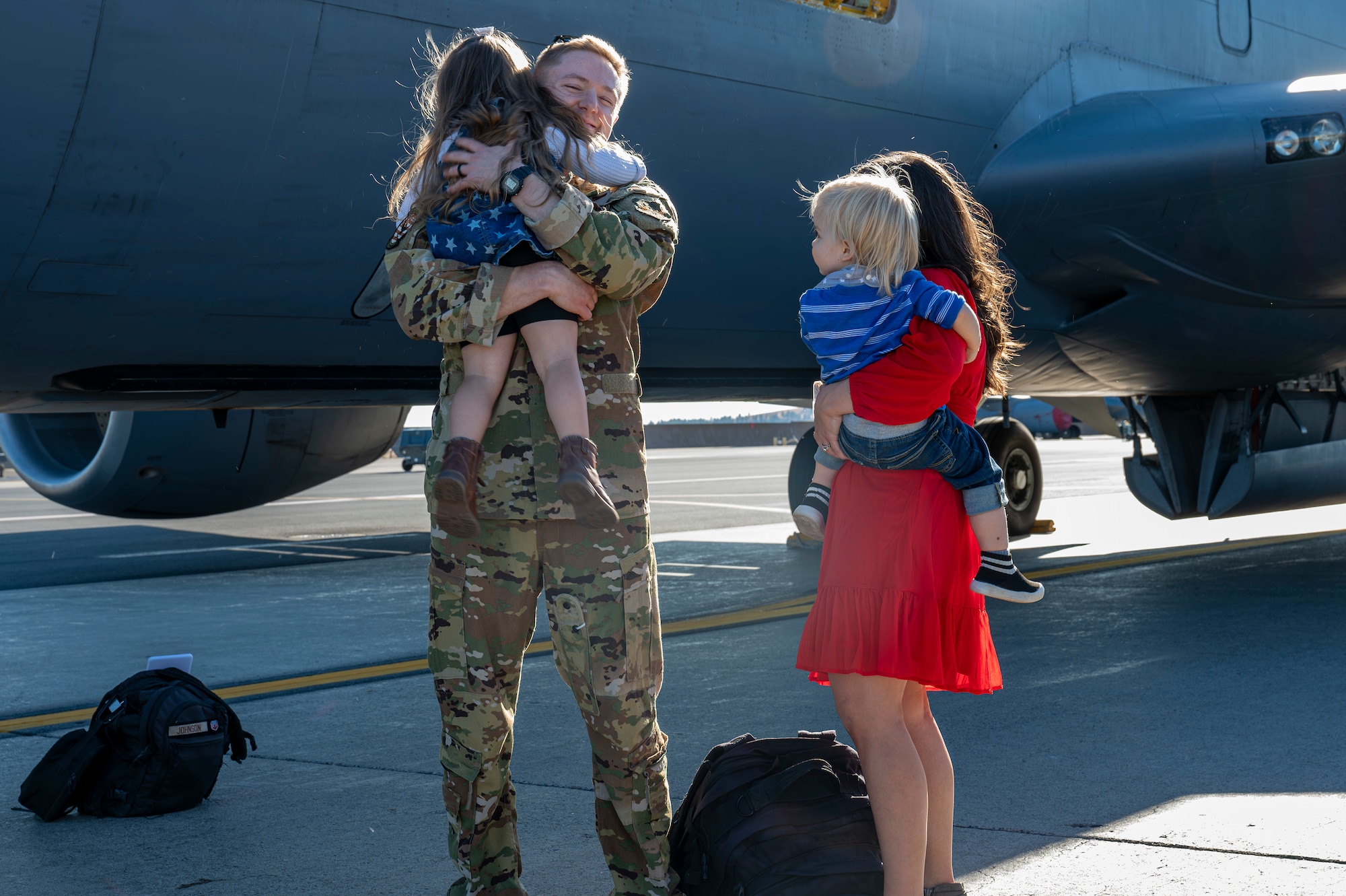 Airman hugs family
