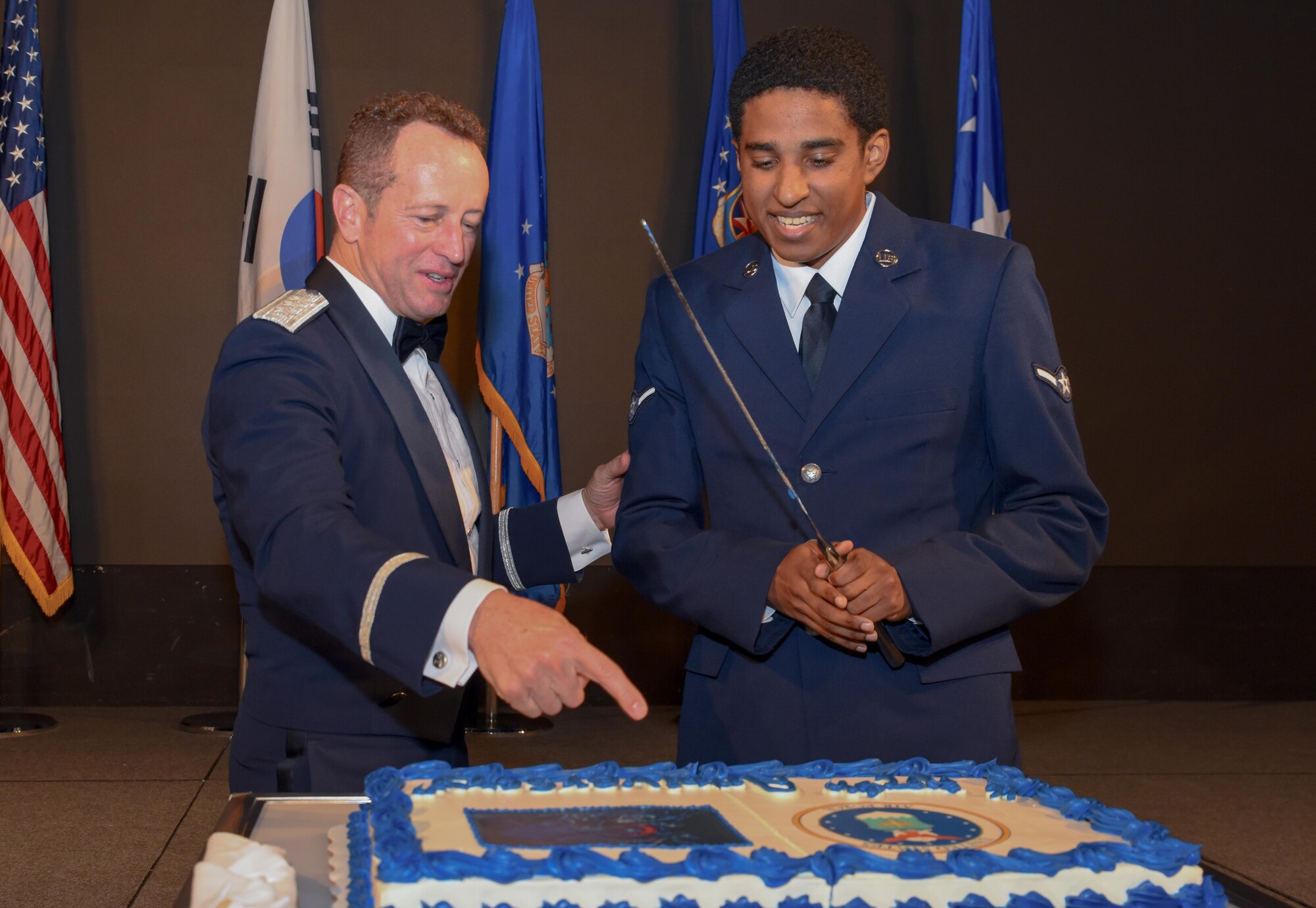 U.S. Air Force Lt. Gen. David R. Iverson, 7th Air Force commander, and Airman Rayland Green, 8th Communications Squadron client systems technician, cut a cake during the 7th AF’s Peninsula Wide AF Ball at the Grand Walkerhill Hotel in Seoul, Republic of Korea, Oct. 4, 2024. The cake cutting tradition is done by choosing the highest ranking and youngest Airman in attendance to cut the cake; the distinct honor commemorates all those who serve. (U.S. Air Force photo by Staff Sgt. Kahdija Slaughter)