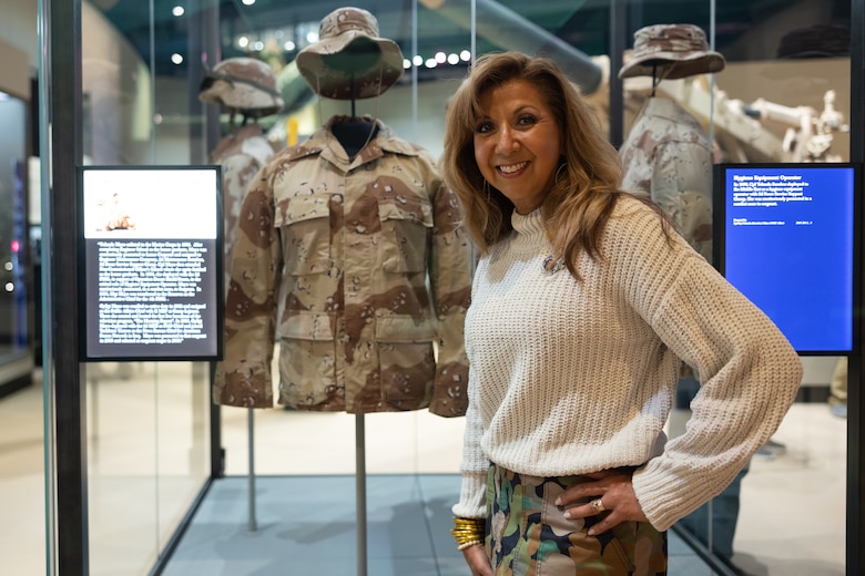 Yolanda Mayo, the Deputy Operations Officer for MCCS Lejeune-New River, stands next to her display at the National Museum of the Marine Corps in Triangle, VA, Oct 6, 2024. The National Museum of the Marine Corps opened the new Forward Deployed and Iraq & Afghanistan galleries to the public.