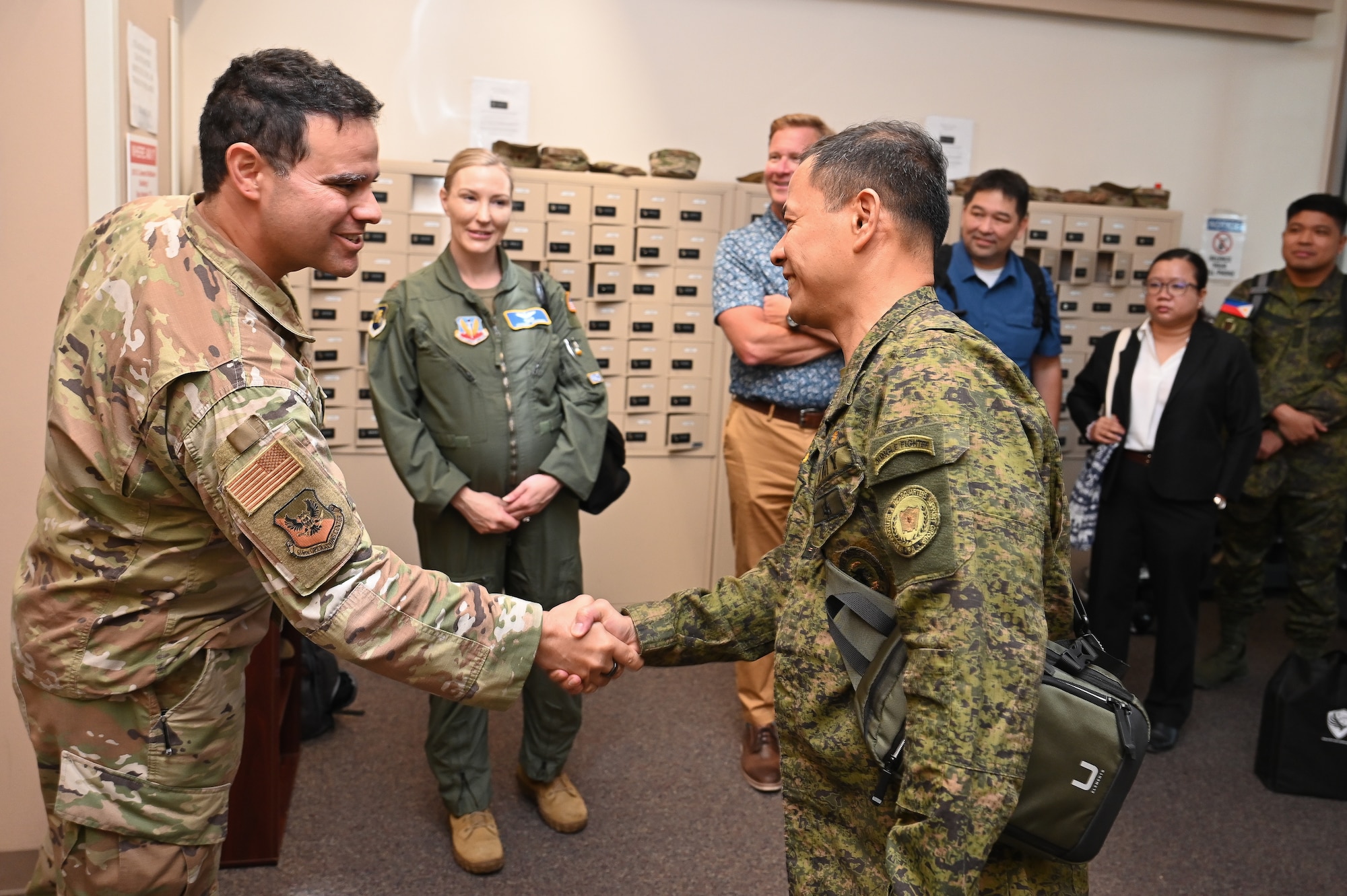 616th Operation Center leadership shake hands with Philippine Army leadership in a hallway.