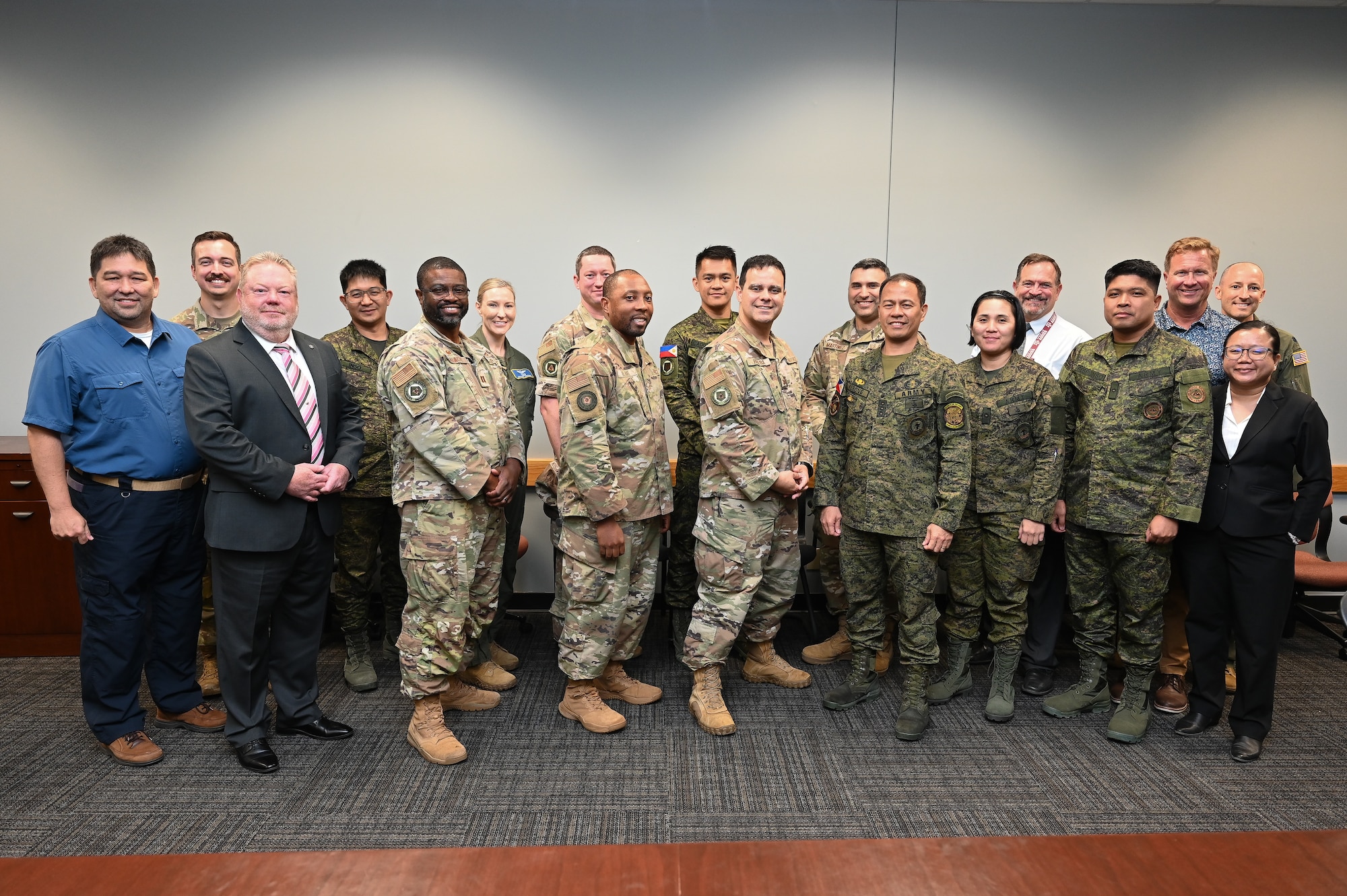 Philippine Army and 16th Air Force members pose for a group photo in a conference room.