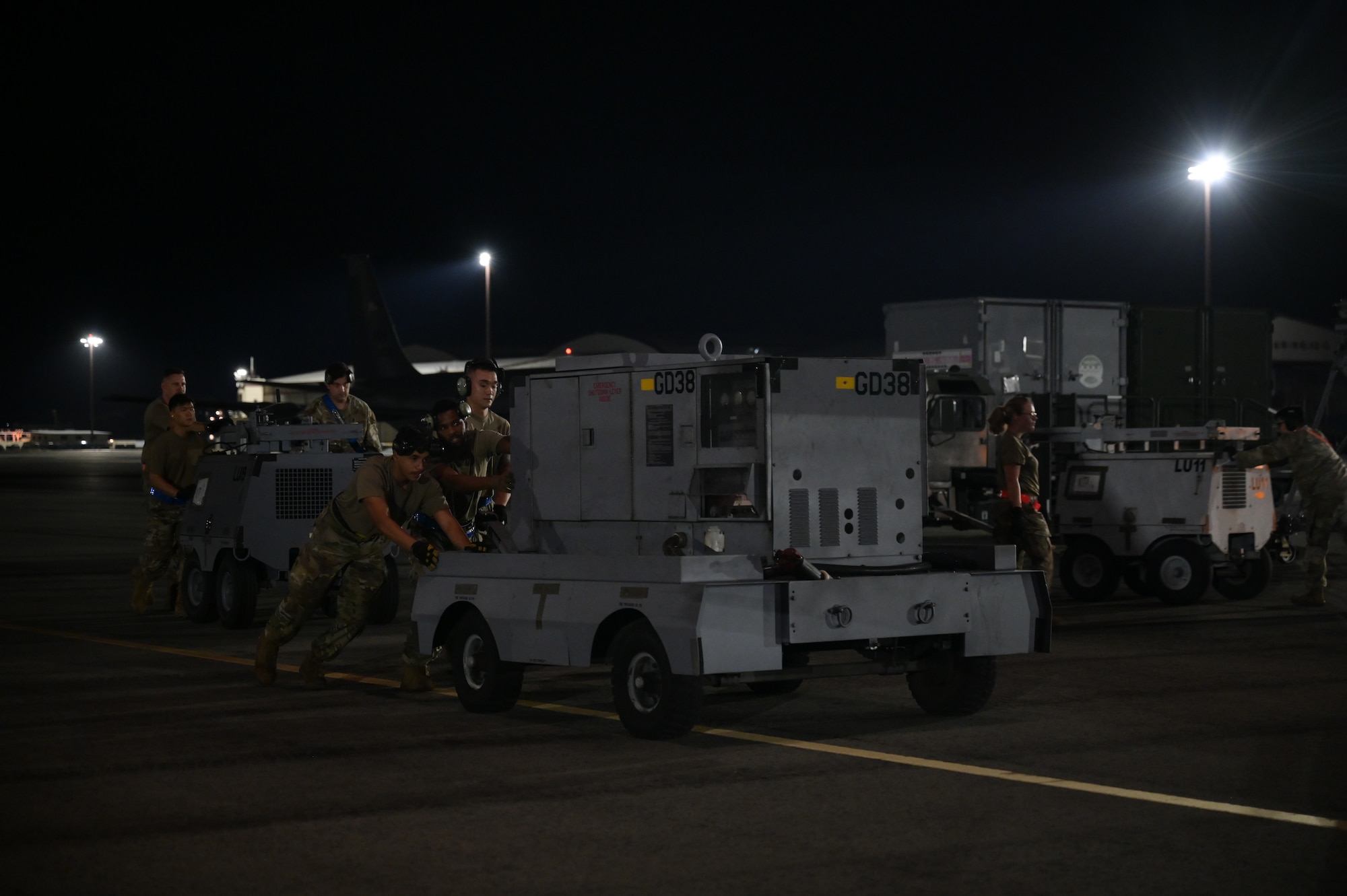 U.S. Air Force Airmen assigned to the 735th Air Mobility Squadron load cargo onto a C-17 Globemaster III during Joint Pacific Multinational Readiness Center, at Joint Base Pearl Harbor-Hickam, Hawaii, Oct. 5, 2024. The Joint Pacific Multinational Readiness Center (JPMRC) is the Army’s newest Combat Training Center (CTC) and generates readiness in the environments and conditions where our forces are most likely to operate in. JPMRC 25-01 includes training participants from across the U.S. Joint Force, and multinational Allies and partners. (U.S. Air Force photo by Staff Sgt. Alan Ricker)