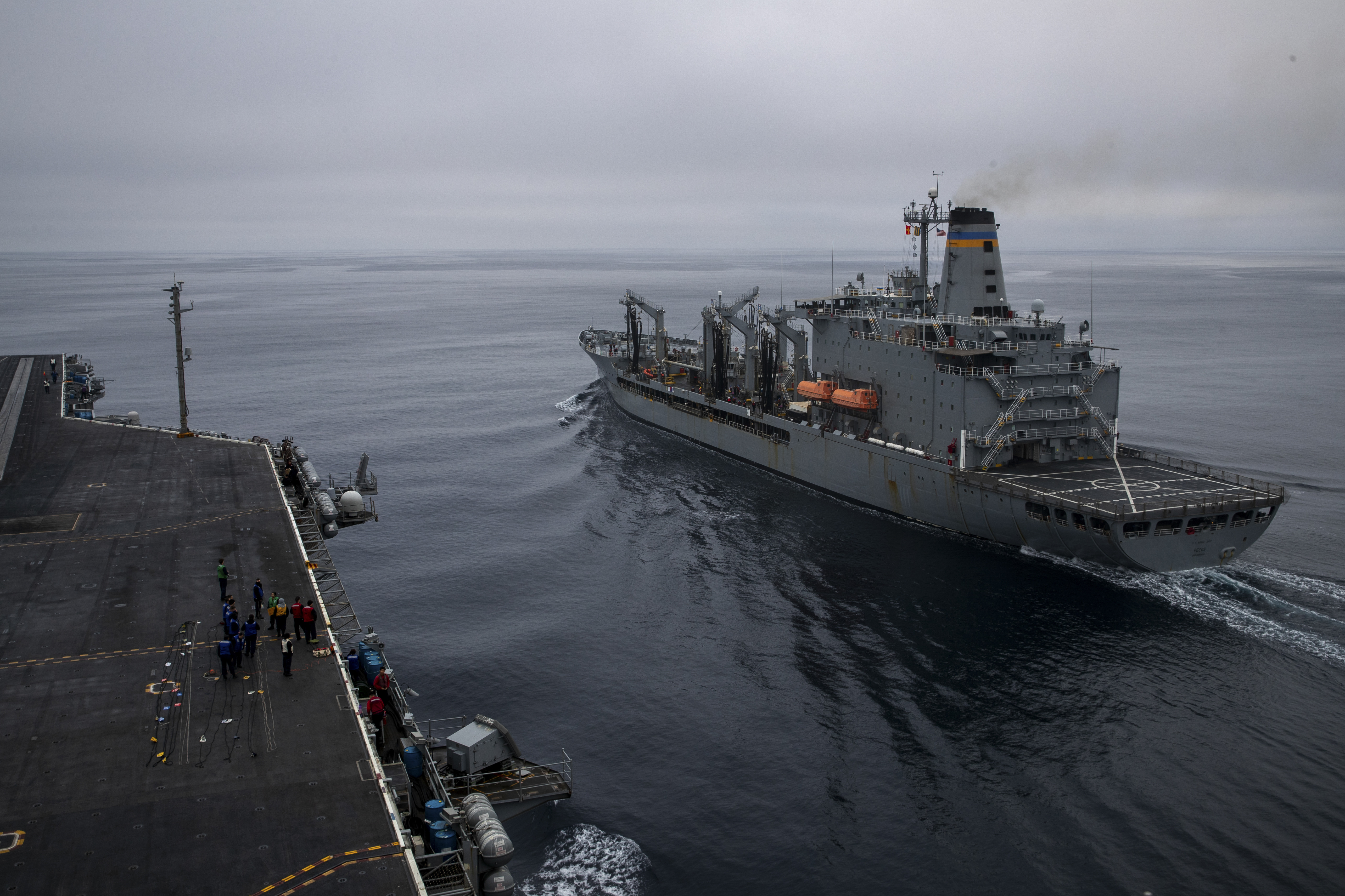 Nimitz-class aircraft carrier USS George Washington (CVN 73) steams alongside Henry J. Kaiser-class fleet replenishment oiler USNS Pecos (T-AO-197) prior to a fueling-at-sea in the Pacific Ocean, Oct. 5, 2024.