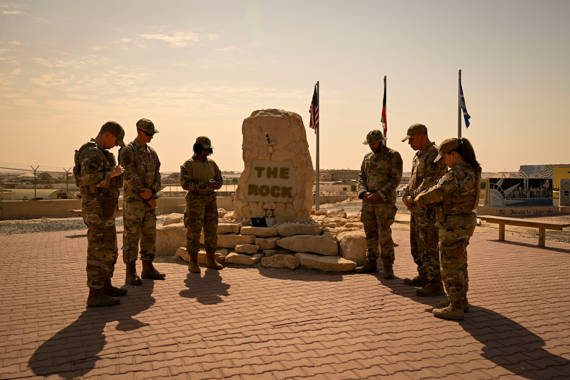 Six U.S. Air Force Airmen gather for a ceremony.