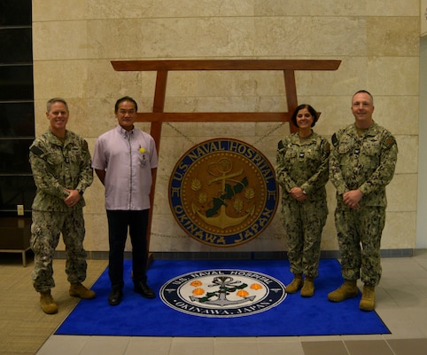 OKINAWA, Japan (Oct. 3, 2024) – Capt. Kathleen Cooperman, commanding officer, U.S. Navy Medicine Readiness and Training Command (NMRTC), center right, the City of Ginowan Mayor Mr. Atsushi Sakima, center left, Capt. James Demitrack, executive officer, NMRTC, far right, and Command Master Chief Thomas Perkins pose for a photo, Oct. 3, 2024.  (U.S.  Navy photo by Mass Communication Specialist 2nd Class Trey Fowler)