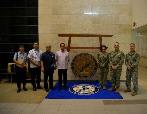 OKINAWA, Japan (Oct. 3, 2024) -- Capt. Kathleen Cooperman, commanding officer, U.S. Navy Medicine Readiness and Training Command (NMRTC), center right, and the official party pose for a photo with the City of Ginowan Mayor Mr. Atsushi Sakima, center left, and City of Ginowan’s official party, Oct. 3, 2024. (U.S.  Navy photo by Mass Communication Specialist 2nd Class Trey Fowler)