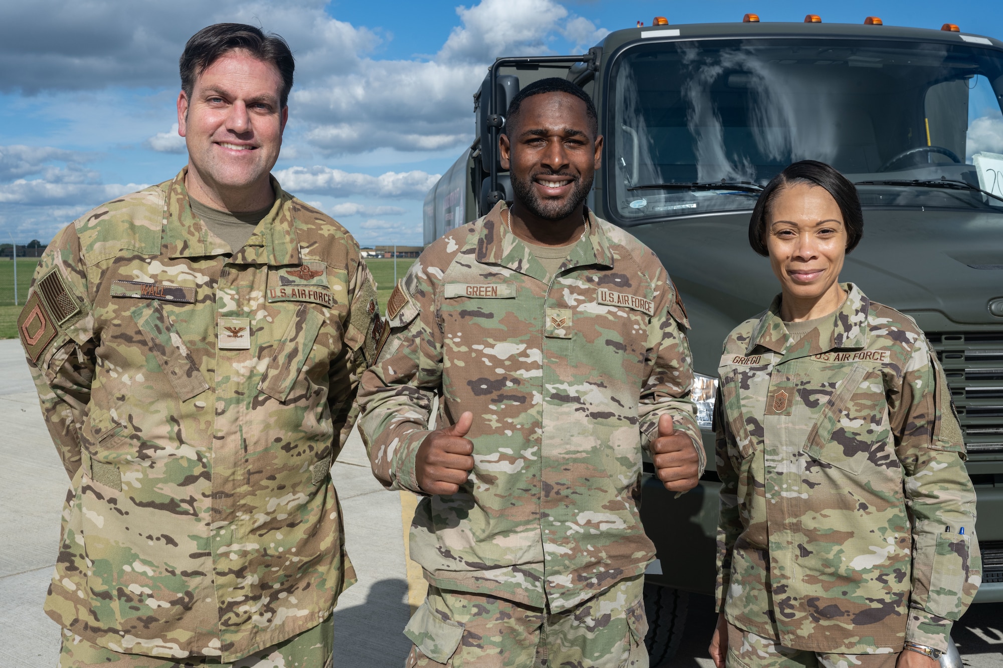 U.S. Air Force Senior Airman Jovon Green, center, poses for a photo with Col. Joseph Wall, left, 100th Air Refueling Wing deputy commander, and Chief Master Sgt. Tiffany Griego, 100th ARW command chief at Royal Air Force Mildenhall, England, Oct. 4, 2024.