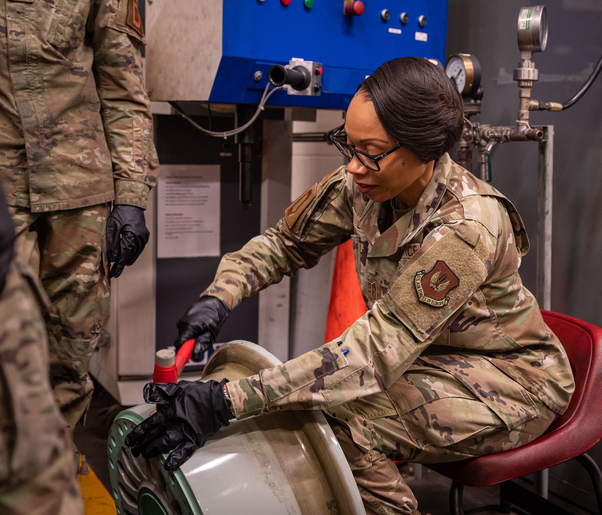 U.S. Air Force Chief MSgt. Tiffany Griego, 100th Air Refueling Wing command chief, hammers an overinflation plug into a KC-135 Stratotanker wheel at Royal Air Force Mildenhall, England, Oct. 4, 2024.