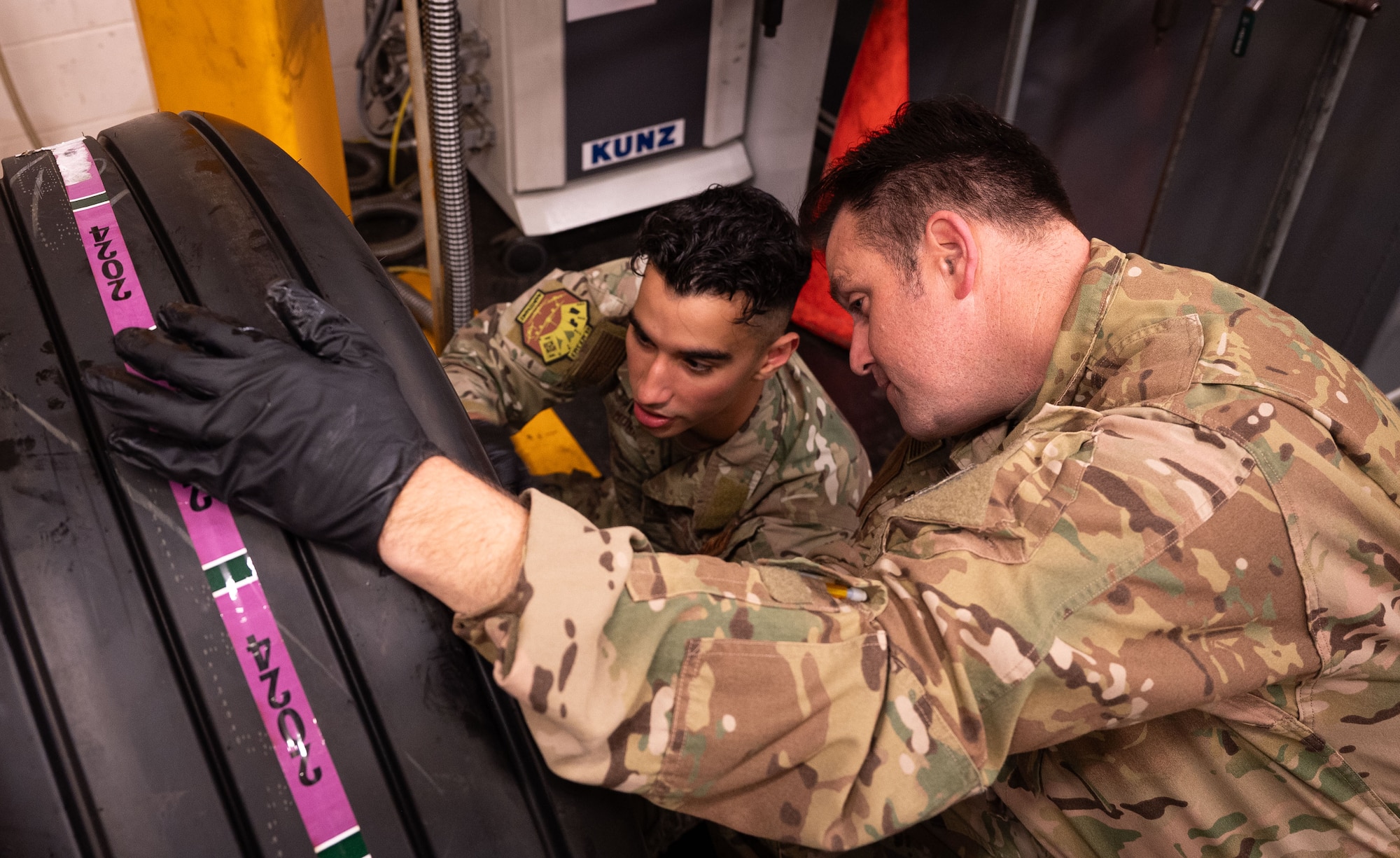 U.S. Air Force Senior Airman Nathaniel Morin, left, 100th Aircraft Maintenance reclamation and repair journeyman, demonstrates how to identify the correct star pattern for bolt tightening to Col. Joseph Wall, 100th Air Refueling Wing deputy commander, at Royal Air Force Mildenhall, England, Oct. 4, 2024.