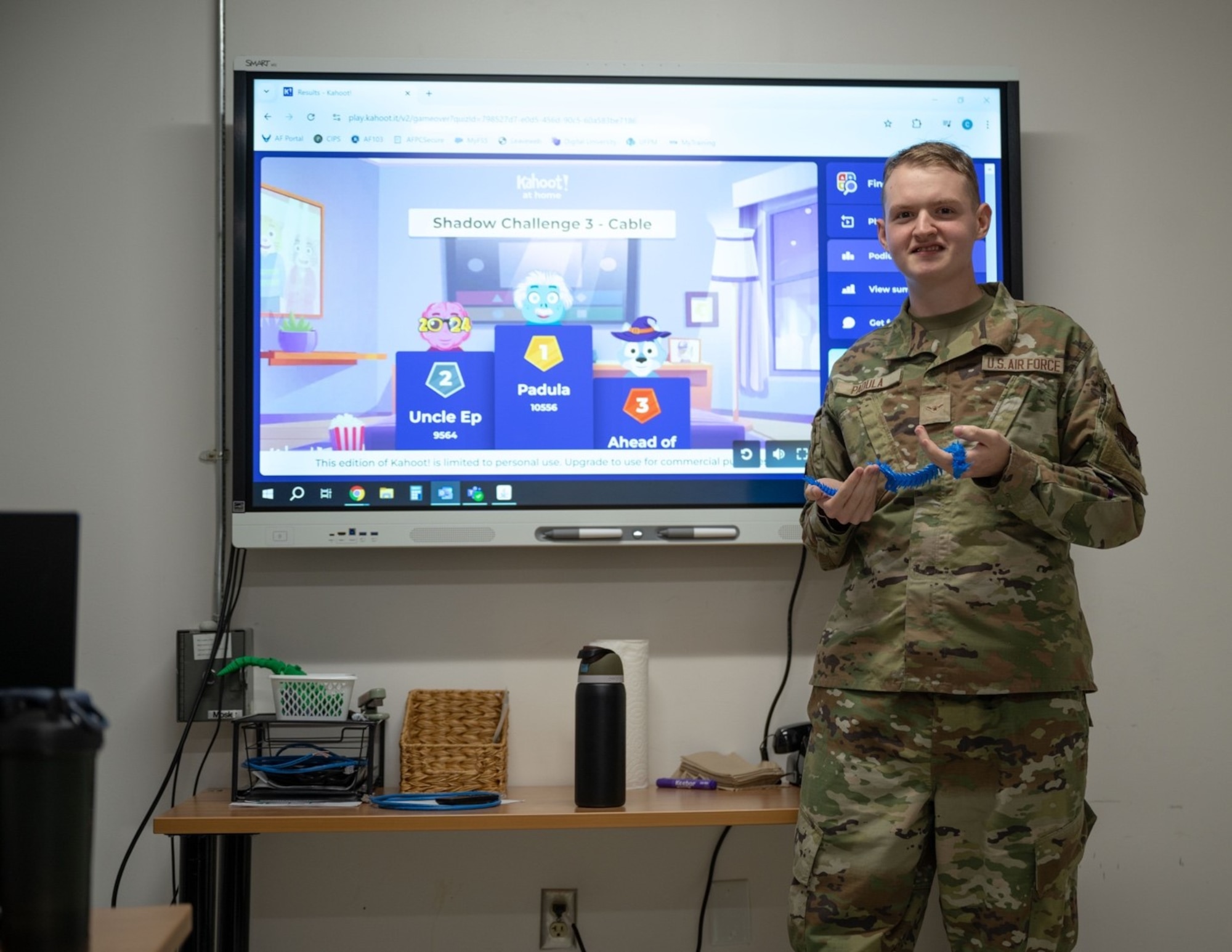 Airman Padula poses for a photo with a blue dragon prize.