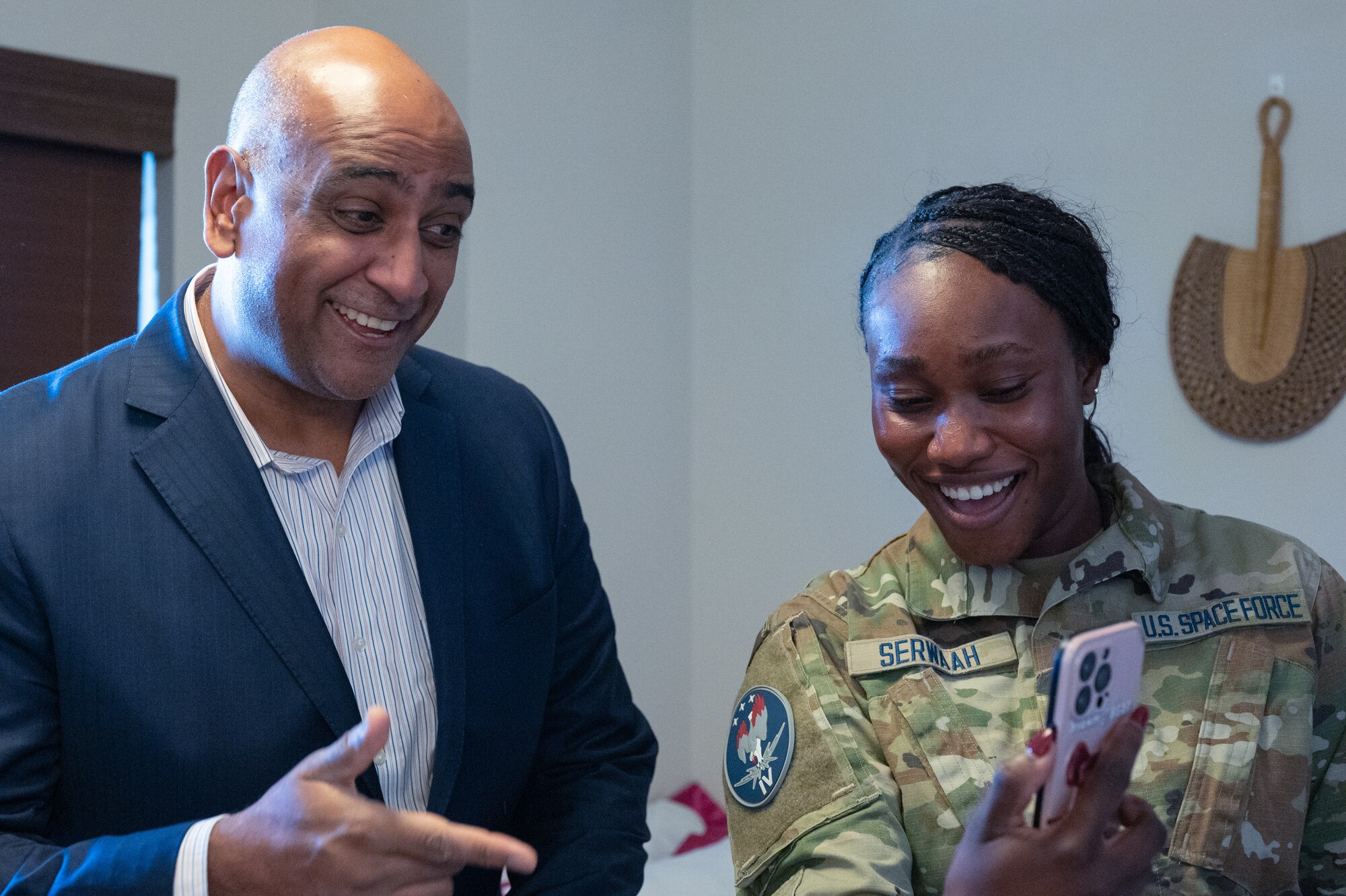 Dr. Ravi Chaudhary video chats with Spc. Serwaah's sister during a tour of the unaccompanied housing tour.