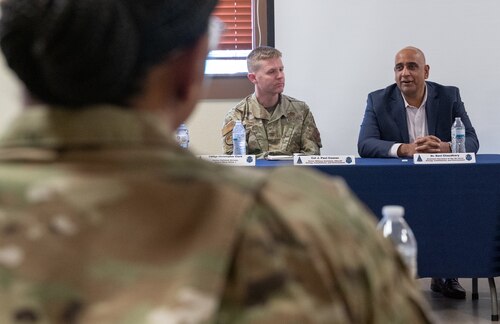 Dr. Ravi Chaudhary sits with Space Base Delta 1 leadership while having a discussion with residents from privatized hoursing.