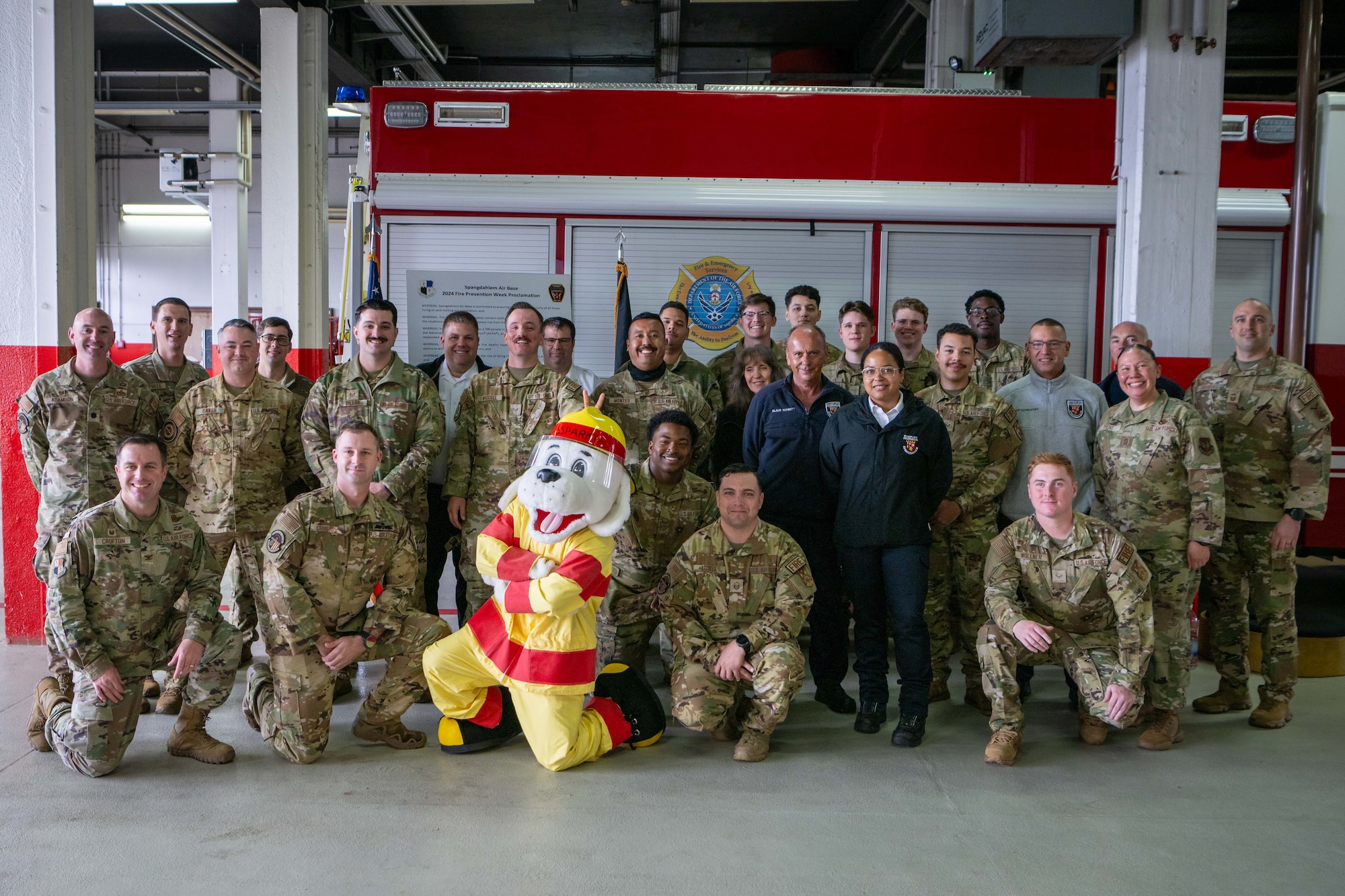 52nd Fighter Wing Leadership and members of the 52nd Civil Engineer Squadron Fire Department pose for a group picture during the Fire Prevention Week Proclamation signing at Spangdahlem Air Base, Germany, Oct. 4, 2024.