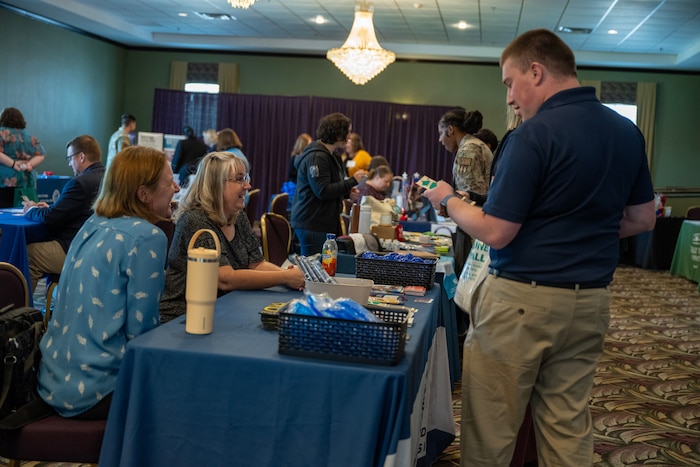 Attendees of the Wright-Patt Junior Force Council Annual Leadership Symposium interact with base agencies at their booths.