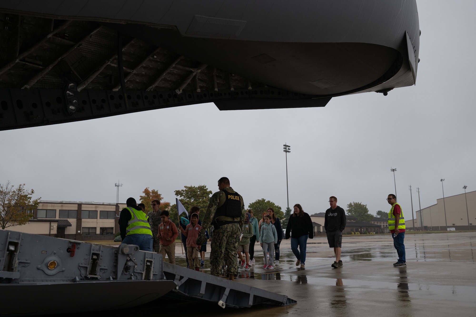 Service members and their families board a C-17 Globemaster III aircraft during a Kids Understanding Deployment Operations event at Joint Base McGuire-Dix-Lakehurst, N.J., Sept. 28, 2024. The KUDOS concept creates a simulated deployment line for service members’ children to process through in order to gain insight on the tasks their parents complete prior to deploying. (U.S. Air Force photo by Staff Sgt. Monica Roybal)