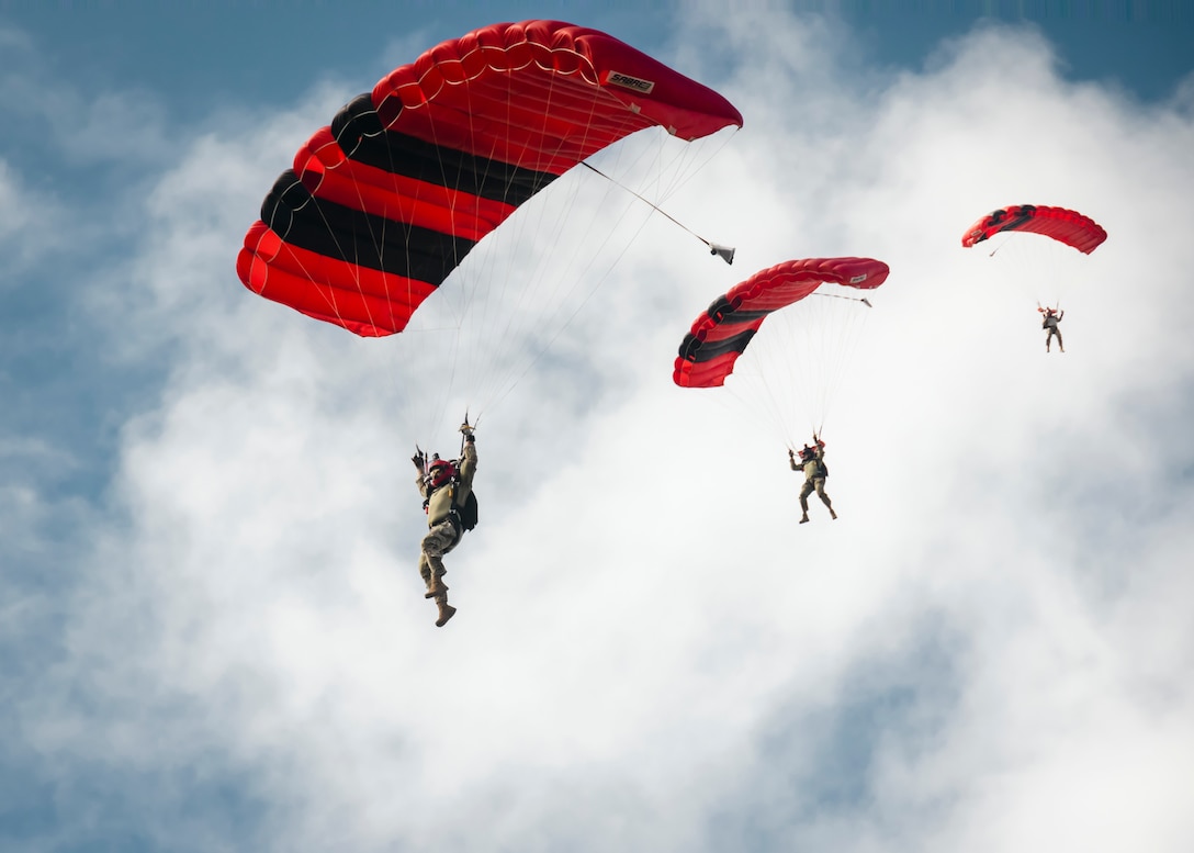 U.S. Special Forces service members descend to Hale Koa landing zone at Marine Corps Base Hawaii, Sept. 27, 2024. The Special Forces performed jump demonstrations for the public in support of recruiting and to inform individuals on the usage of parachuting in a real-life combat scenario. (U.S. Marine Corps photo by Cpl. Dezmond Browning)