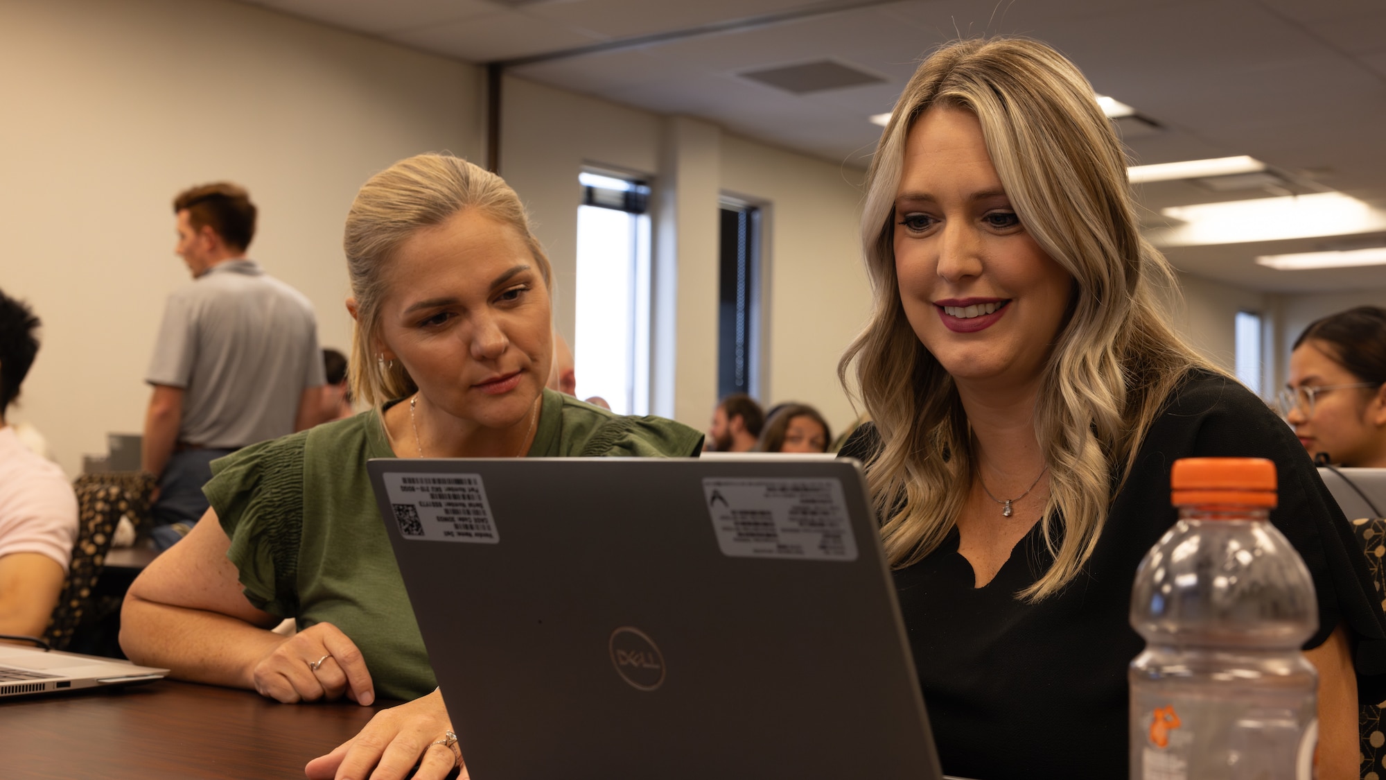 Two women look at a laptop screen