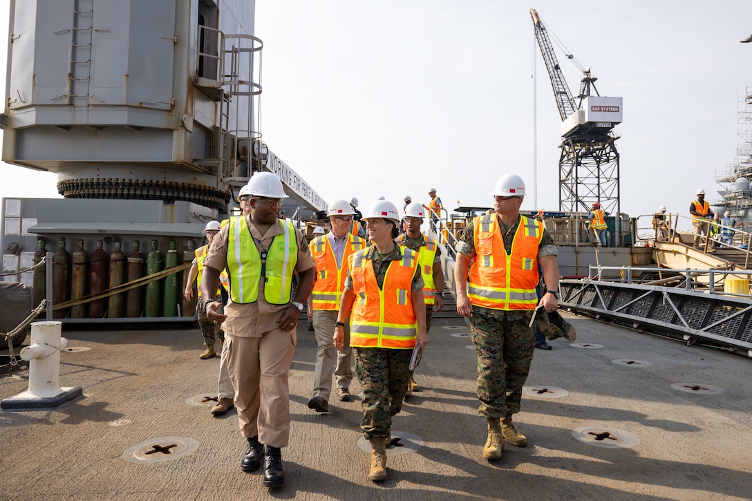 U.S. Marine Corps Lt. Gen. Bobbi Shea, commanding general, Fleet Marine Force, Atlantic, commander, Marine Forces Command, commander, Marine Forces Northern Command, center, discuss readiness of the Harpers Ferry-class dock landing ship USS Carter Hall (LSD 50) with U.S. Navy CMDR. Steven Grey, commanding officer, USS Carter Hall (LSD 50) left, at BAE Systems Norfolk Ship Repair, Aug 28, 2024. During the visit, Shea toured the ship and spoke with subject matter experts to deepen understanding of the readiness, capabilities, and warfighting capacities of the vessel and to strengthen existing relationships with key leaders of the shipyard. The USS Carter Hall is part of the Bataan Amphibious Ready Group in Expeditionary Strike Group (ESG) 2. (U.S. Marine Corps photo by Staff Sgt. Servante R. Coba)