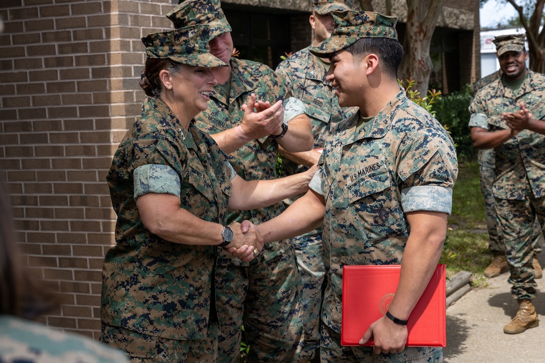 U.S. Marine Corps Lt. Gen. Bobbi Shea, commanding general, Fleet Marine Force, Atlantic, commander, Marine Forces Command, commander, Marine Forces Northern Command congratulates meritoriously promoted Sgt. Carlos Moreno Hernandez at Naval Support Activity Northwest Annex, Chesapeake, Virginia, Aug 23, 2024. Shea met with MCSFR Marines, observed training, and engaged with Col. Scott Reed, commanding officer, Marine Corps Security Force Regiment, as he led discussions on operational topics, health and wellness matters, and future initiatives impacting his subordinate commanders’ Marines and Sailors. (U.S. Marine Corps photo by Lance Cpl. Thirteen Bahizi)