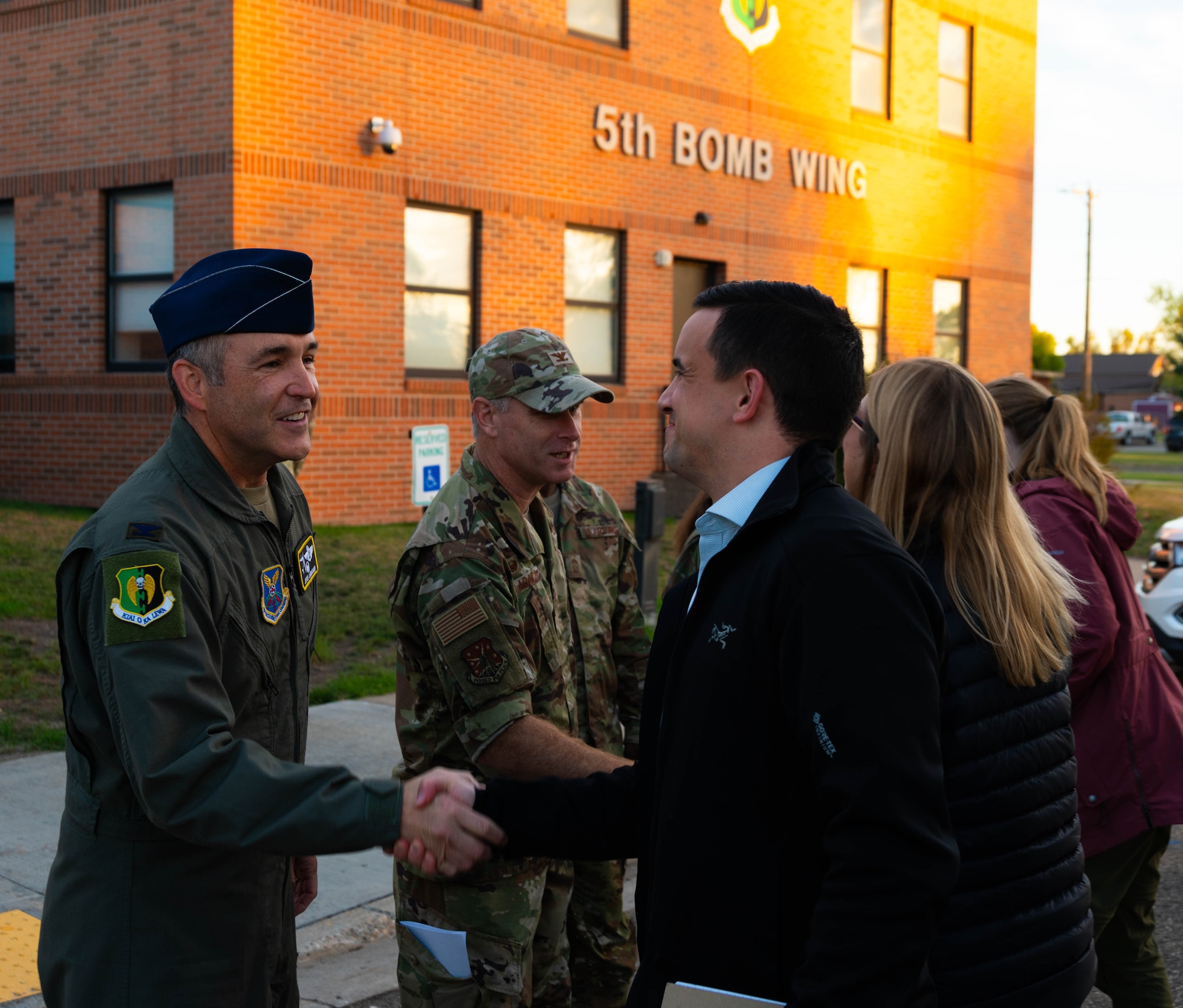 U.S. Air Force Col. Jesse Lamarand, 5th Bomb Wing Commander (left), and U.S. Air Force Col. James Schlabach, 91st Missile Wing commander (center) greet the Congressional Staff Delegation (STAFFDEL) at Minot Air Force Base, North Dakota, Oct. 2, 2024. A STAFFDEL is a group of staff members from a committee or personal office of a member of Congress. (U.S. Air Force photo by Airman 1st Class Luis Gomez)