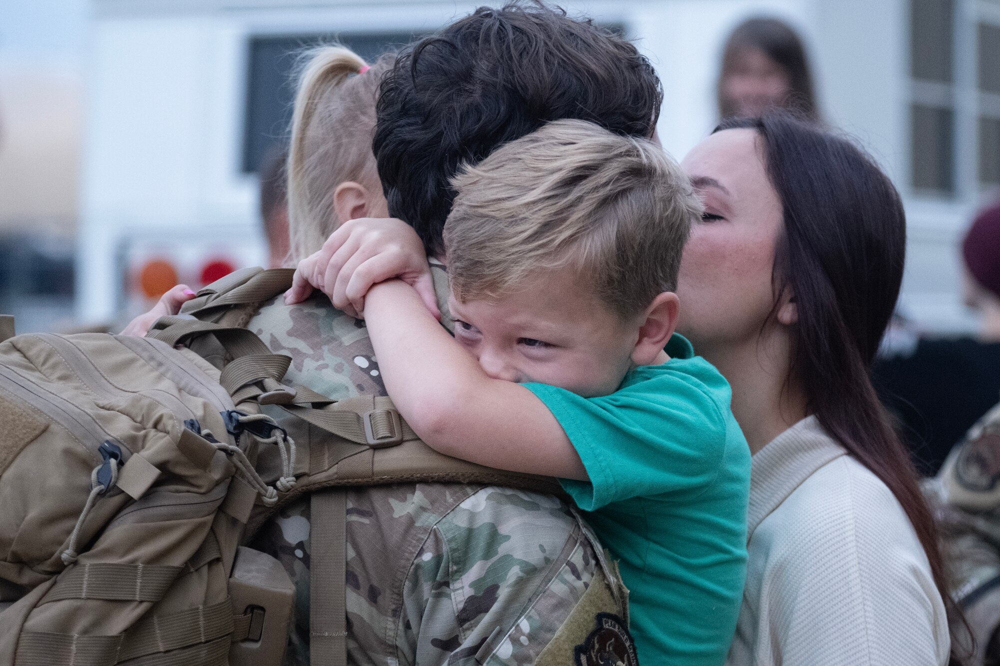 A U.S. Air Force Airman assigned to the 4th Civil Engineer Squadron reunites with his wife and son after returning from a deployment.