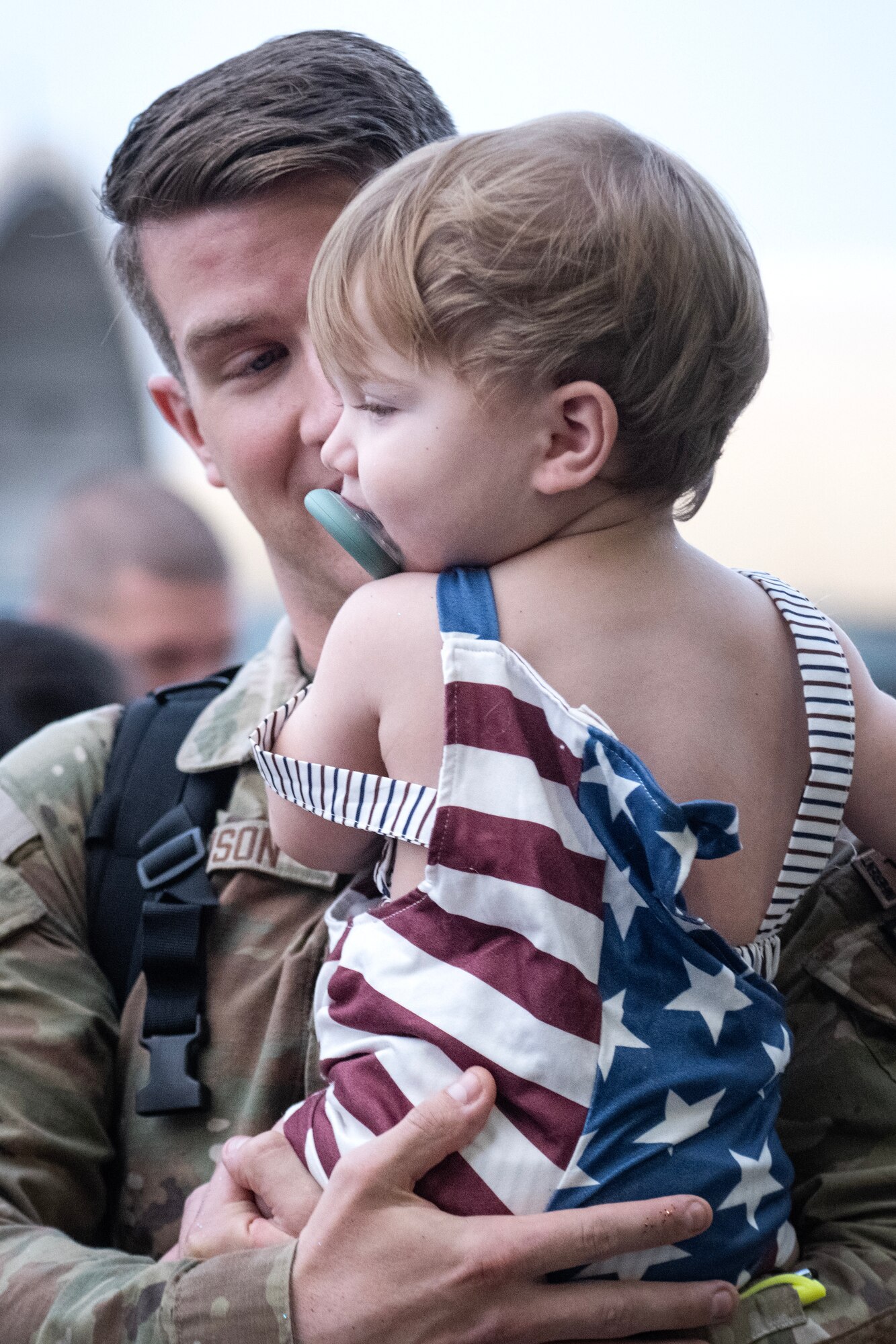A U.S. Air Force Airman assigned to the 4th Communications Squadron reunites with his son after returning from a deployment.