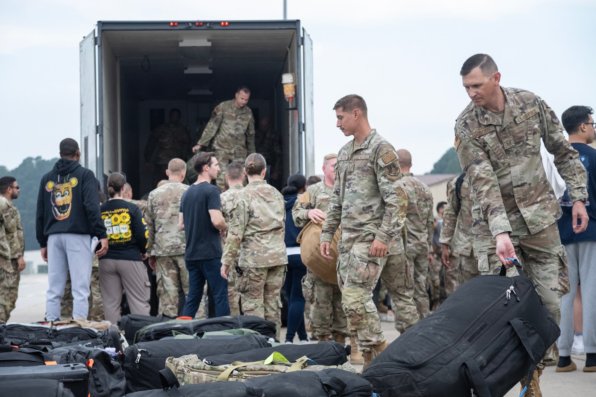 Airmen assigned to the 4th Fighter Wing gather luggage after returning from a deployment.