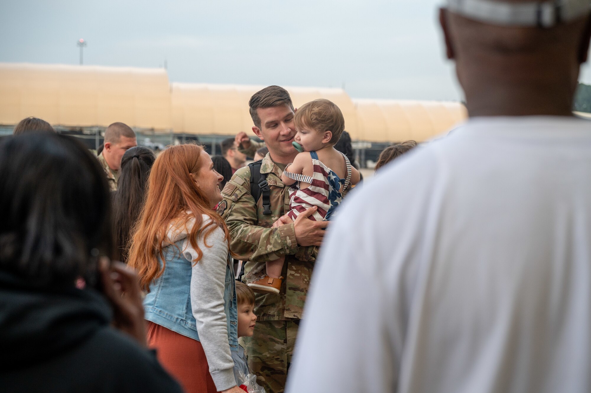 A U.S. Air Force Airman, 4th Communications Squadron, reunites with his son after returning from a deployment.