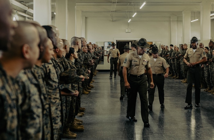 U.S. Marine Corps instructors with Marine Corps Recruit Depot San Diego Drill Instructor School, Recruit Training Regiment, instruct the new Marines of DI school class 1-25 at Marine Corps Recruit Depot San Diego, California, Oct. 3, 2024. DI school develops leadership, command presence, instructional ability, physical fitness, and professional knowledge in officers and noncommissioned officers to prepare them for the duties of a drill instructor.  (U.S. Marine Corps photo by Sgt. Jesse K. Carter-Powell)